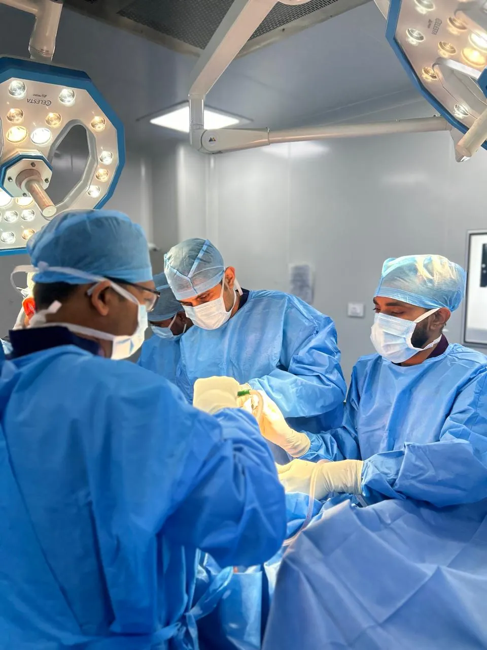 Surgical team scrubbed in before a procedure at Mahaveer Hospital